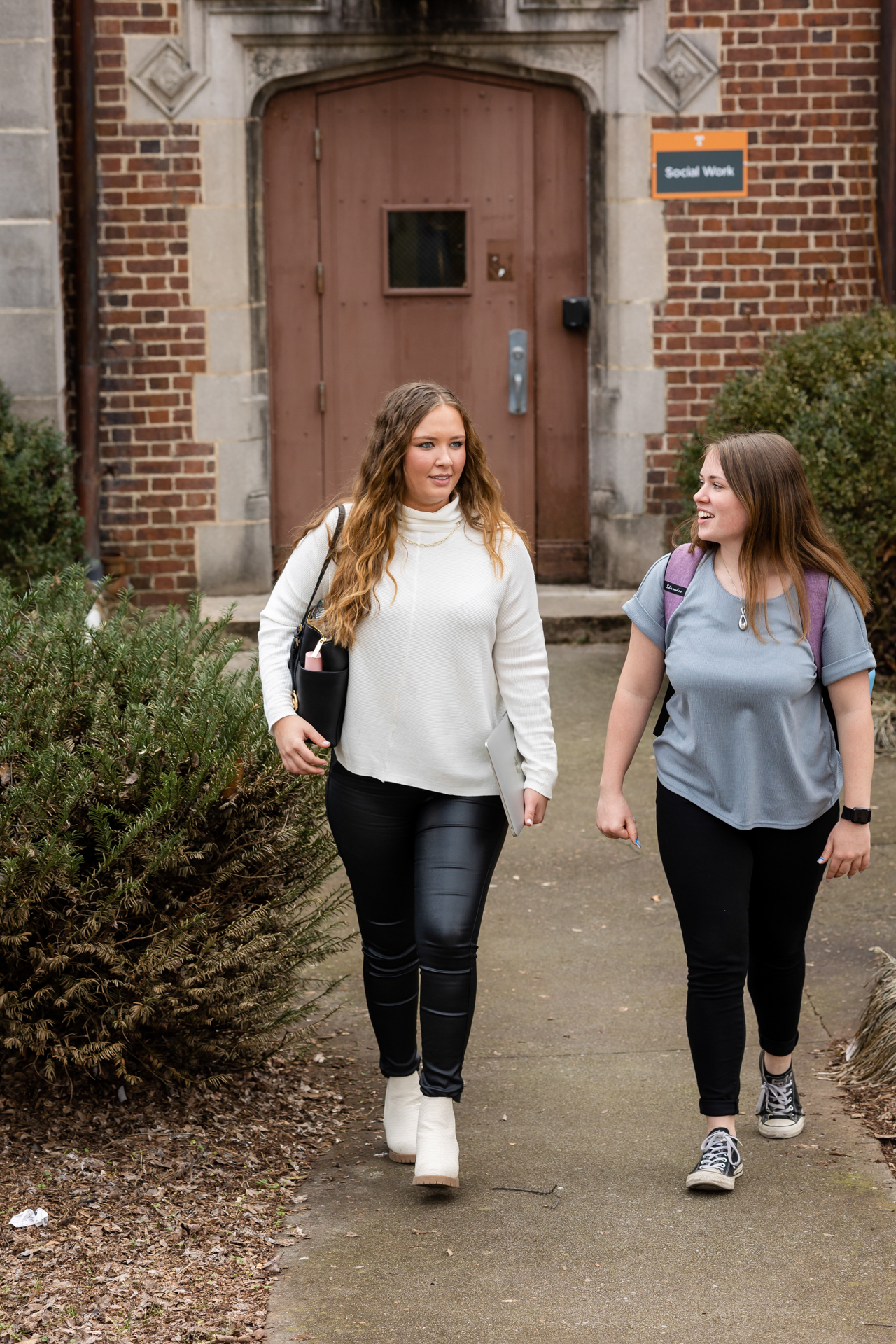 two students walking out the door of Henson Hall
