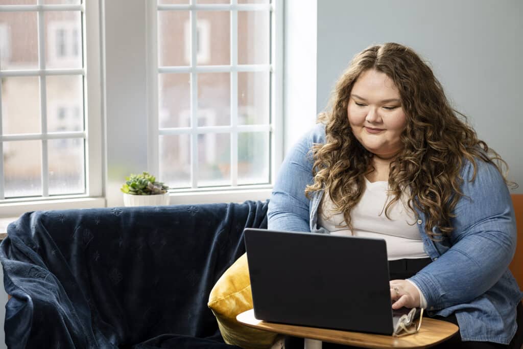 Online BSSW student working on laptop