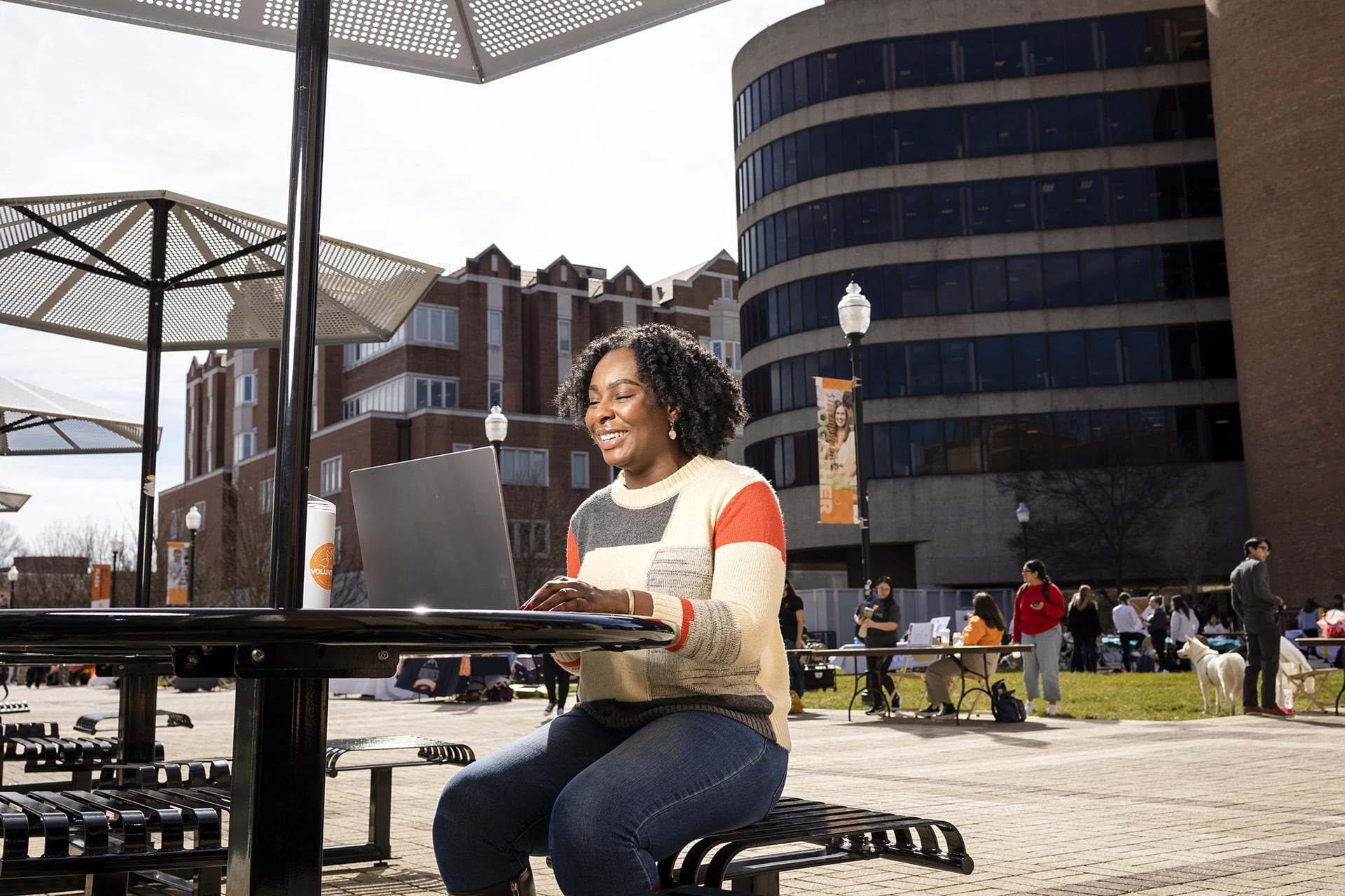 online bssw student working outside on laptop