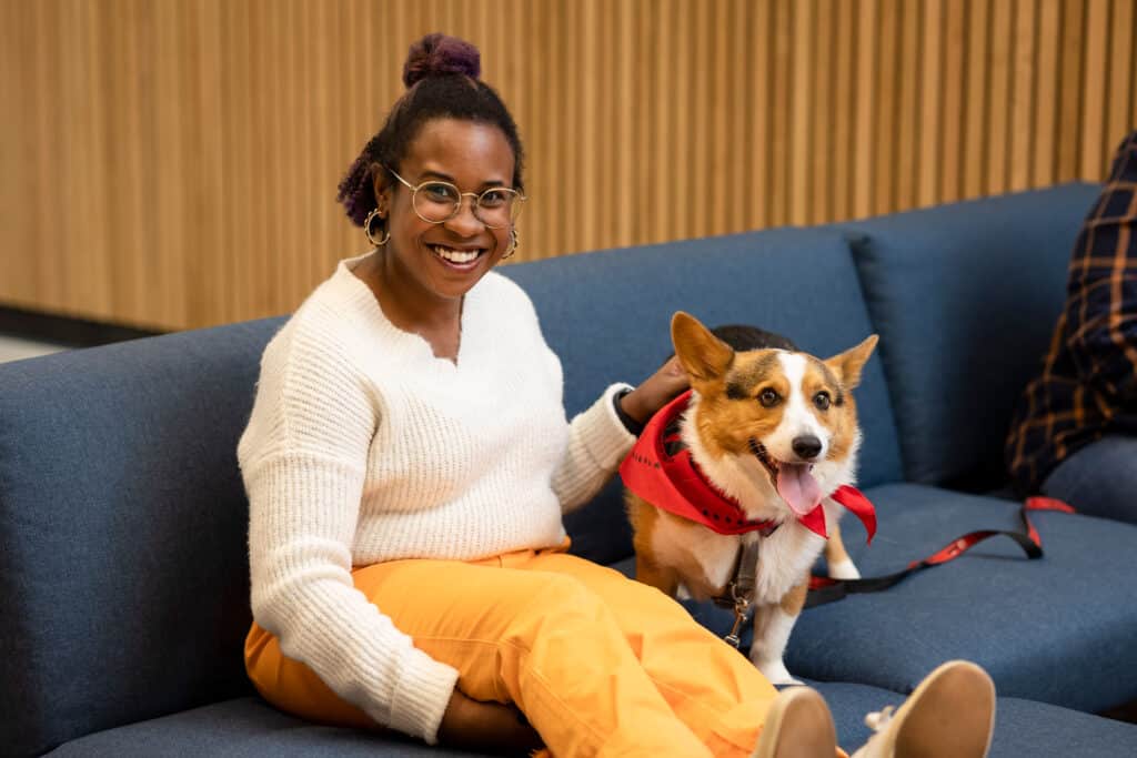 woman sitting with HABIT dog on a couch in the center for veterinary social work