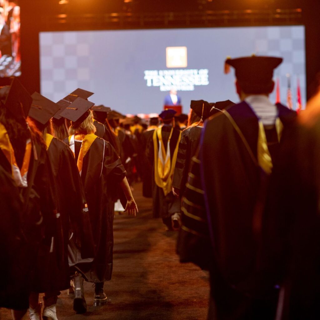 A shot of UTK graduation, with folks in gaps and gowns shot from behind