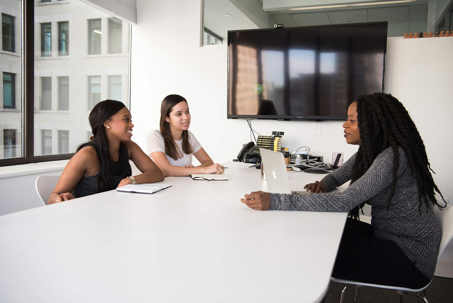 two women interviewing another woman for a job