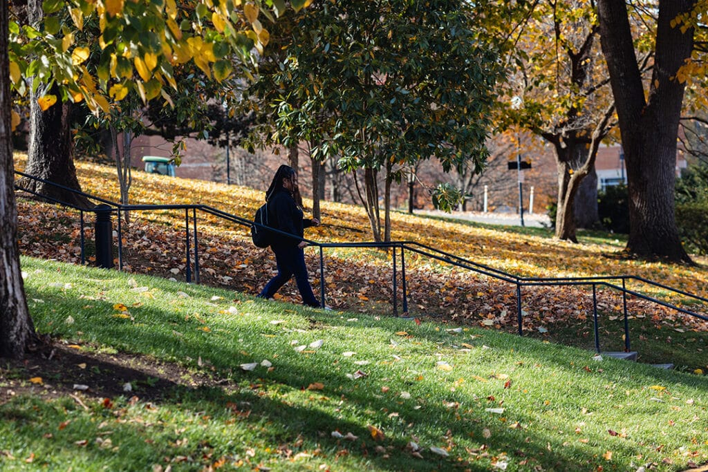 Kenyette Garrett walking down stairs in front of Ayers hall