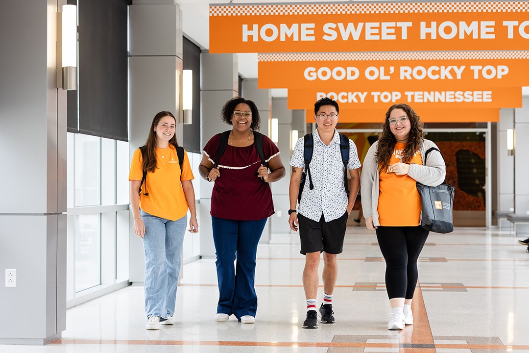 four mssw students walking in the student union