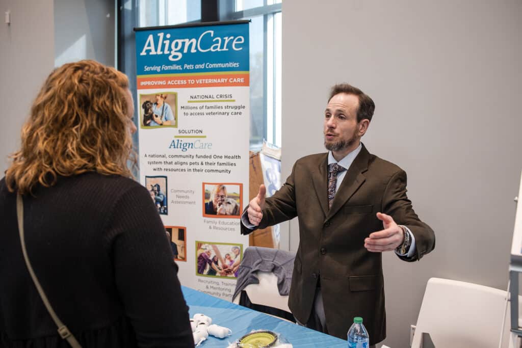 AlignCare worker presenting their services to someone at a conference table 