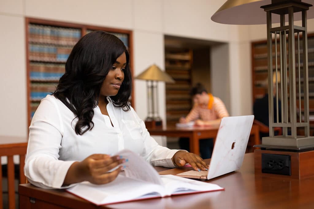 Lifestyle photo of Raven Morris in the College of Law library for Alumni Advancement