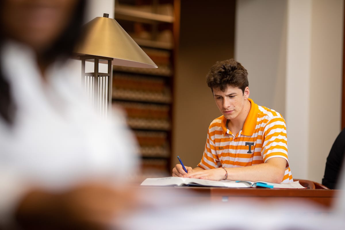 Lifestyle photo of Drew Hyler in the College of Law library for Alumni Advancement