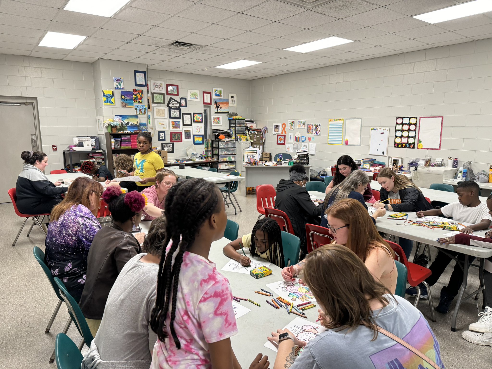 mswo students doing a coloring activity with children