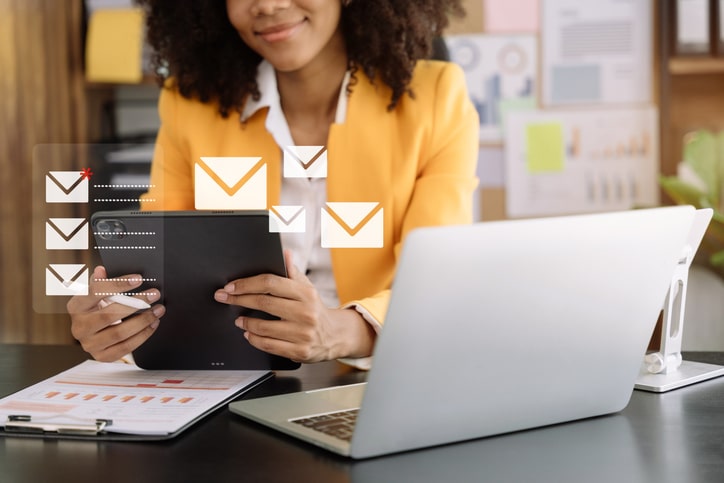 Business email marketing notification concept, Businesswoman use tablet and laptop receive message alert in the mailbox and transfer data at office.