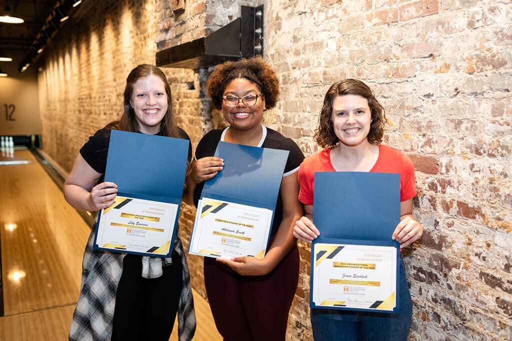 three csw students of the year holding their awards