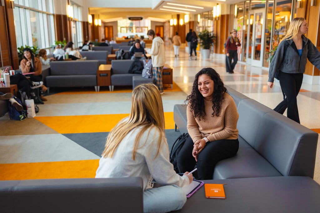 Emily Rodriguez talking with student in UTK student union lobby