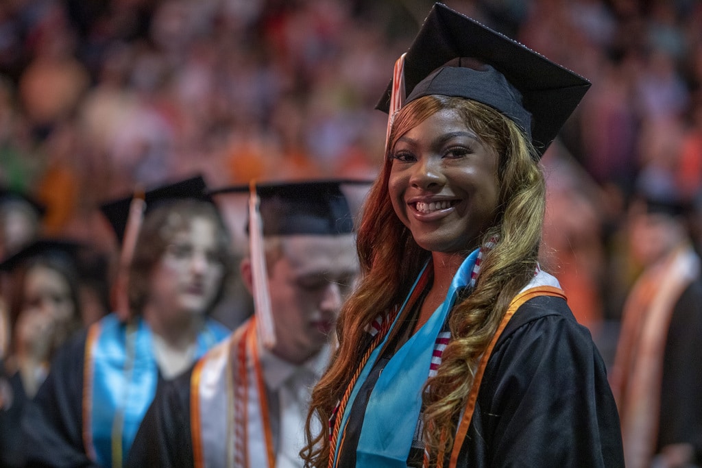 MSSW graduate smiling into camera at commencement