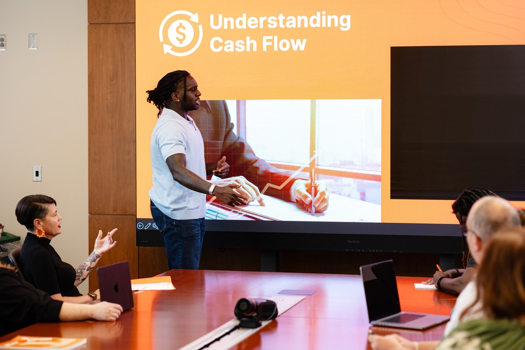 business man talking to a group of people at a presentation