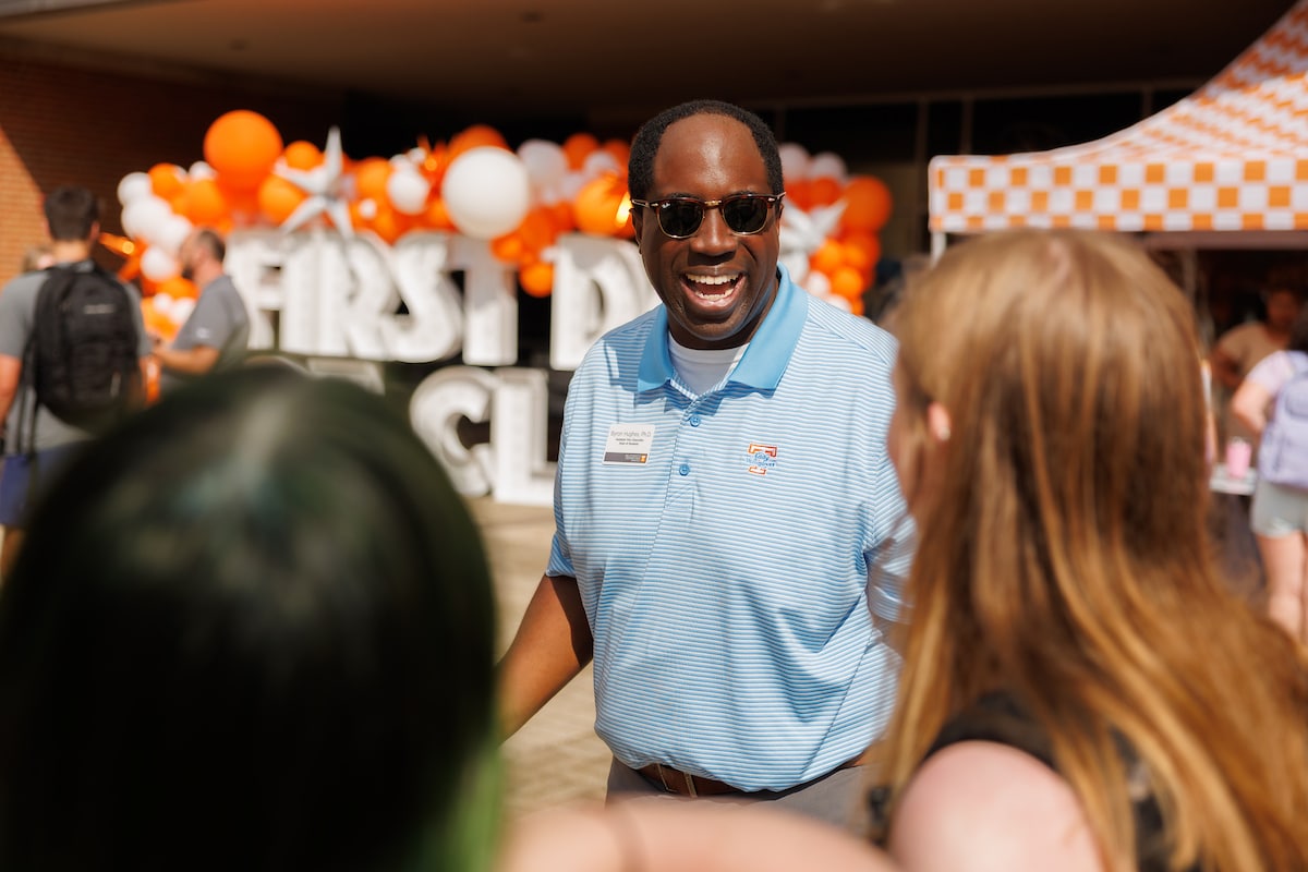 Byron Hughes, Assistant Vice Chancellor for Student Life and Dean of Students, greets students at the Student Union Plaza during the first day of Fall semester classes