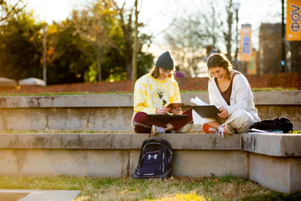 male and female student sitting in amphitheater on University of Tennessee campus 