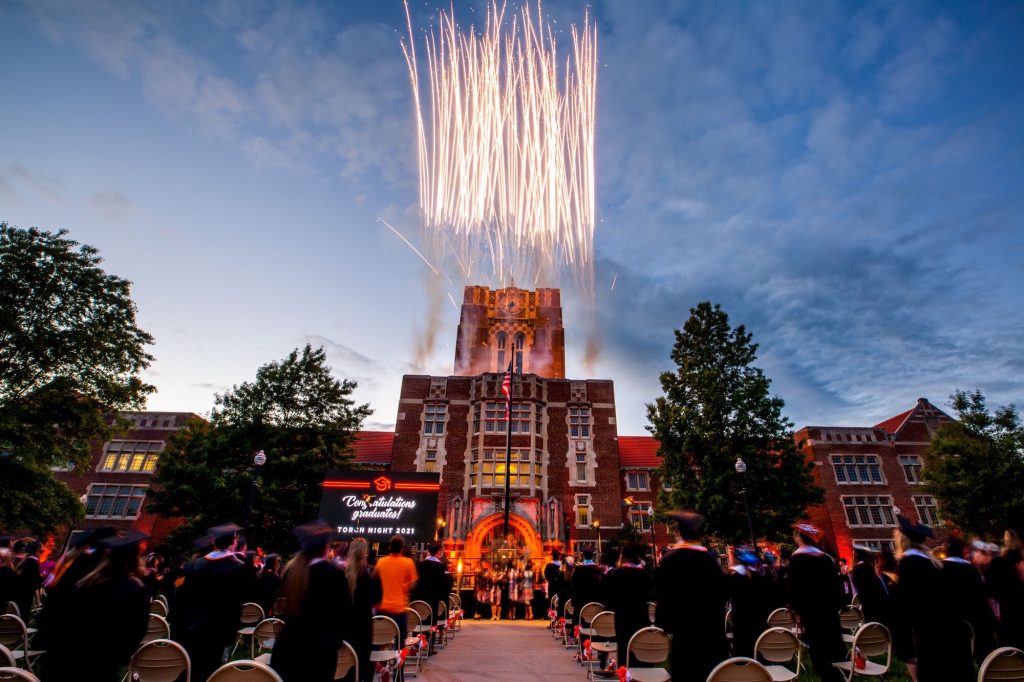 fireworks shooting off top of Ayers hall during graduation torch night