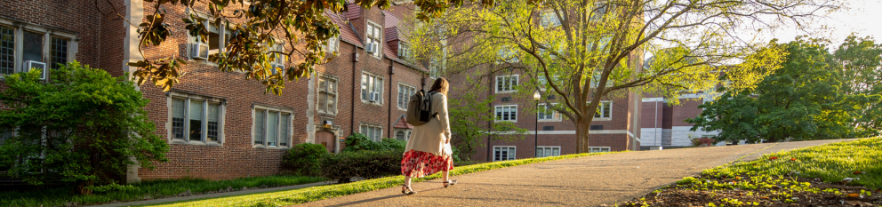 female student walking up hill next to Henson Hall on UTK campus