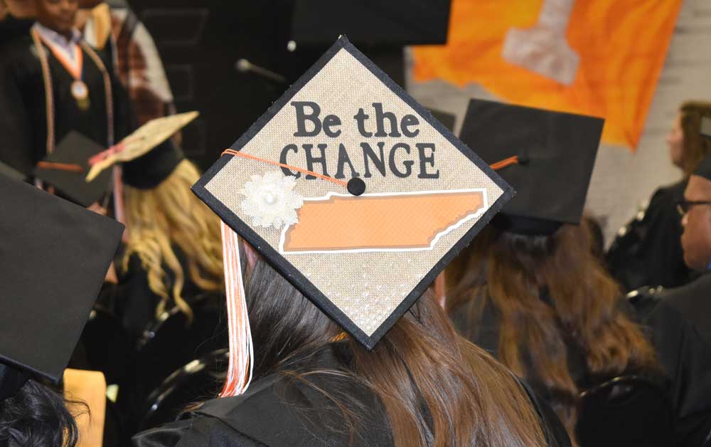 graduate cap with be the change written on top